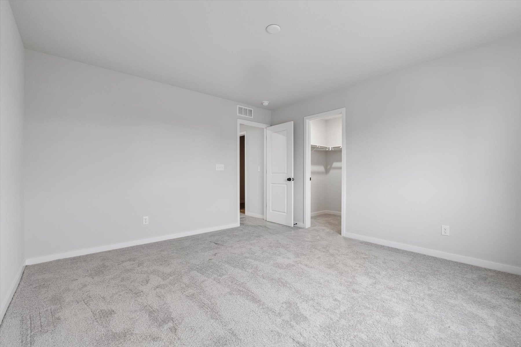 A hallway with white walls.
