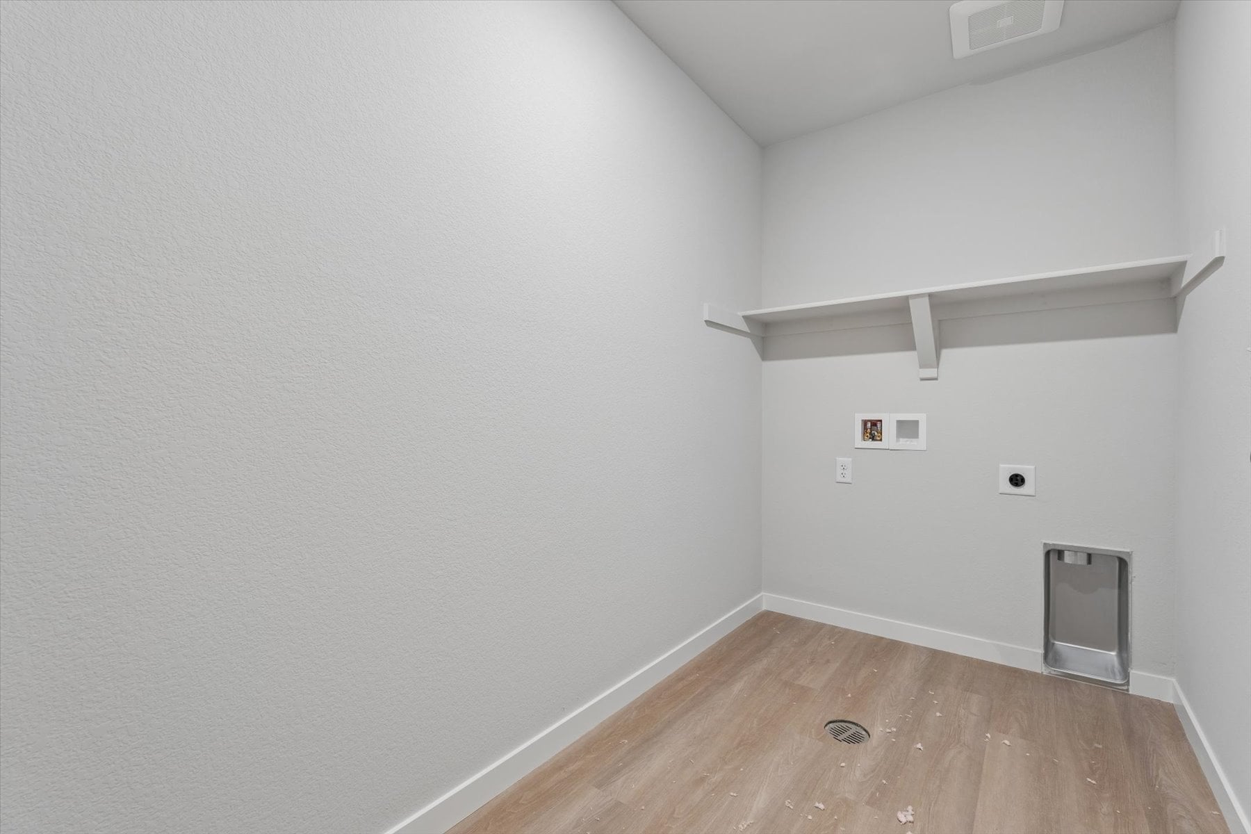 A room with a wood floor and white walls.