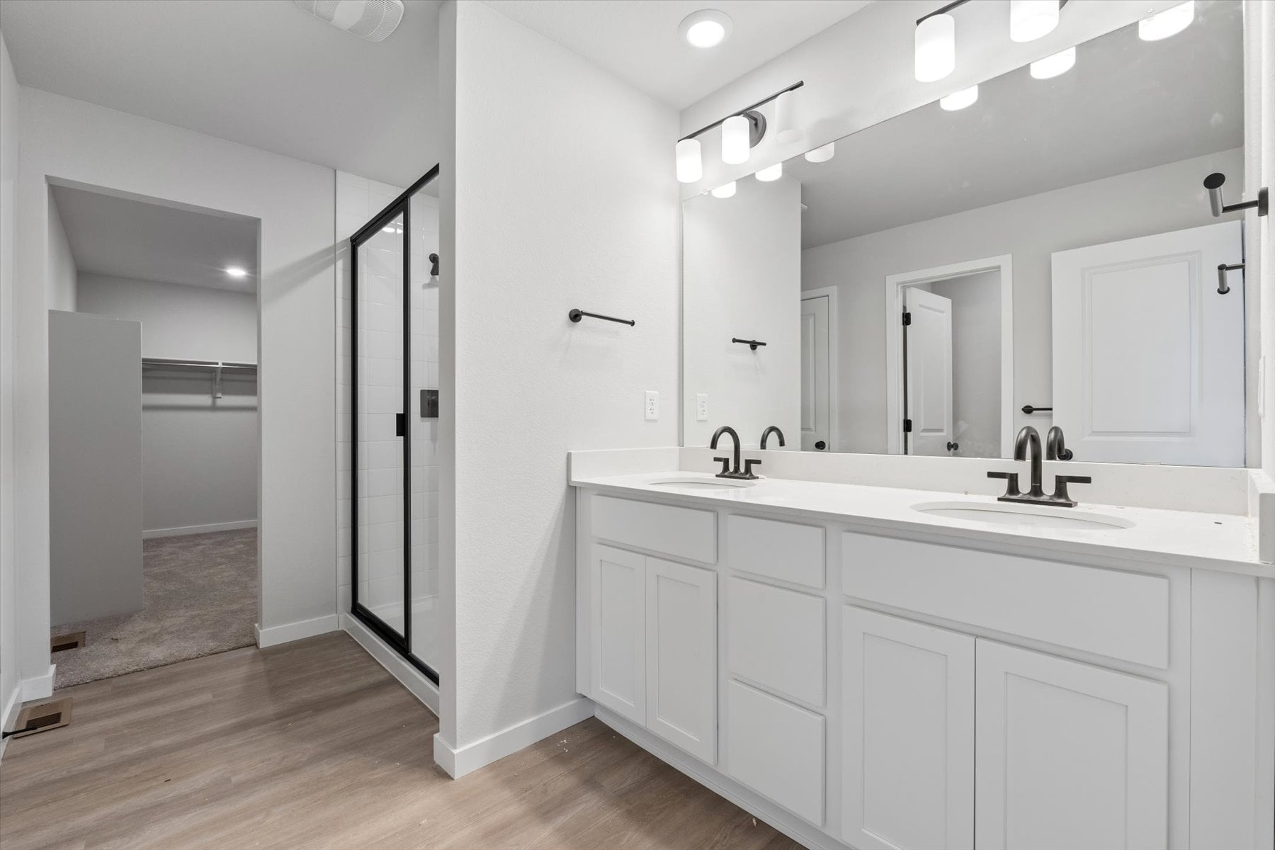 A bathroom with white cabinets.