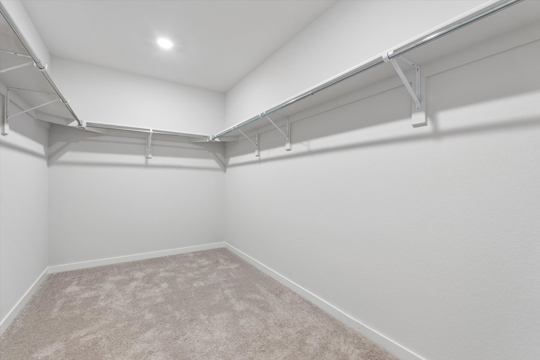 A white room with a carpet.