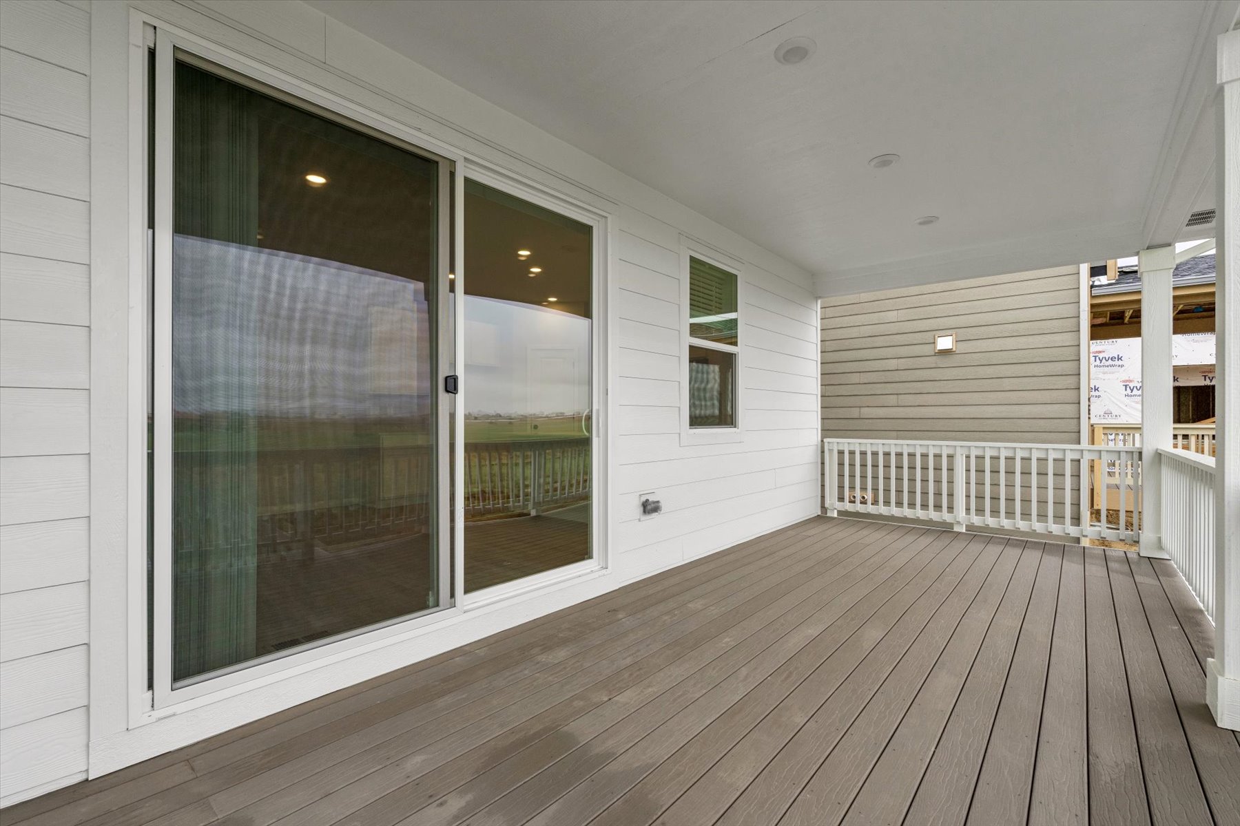 A room with a wood deck and windows.