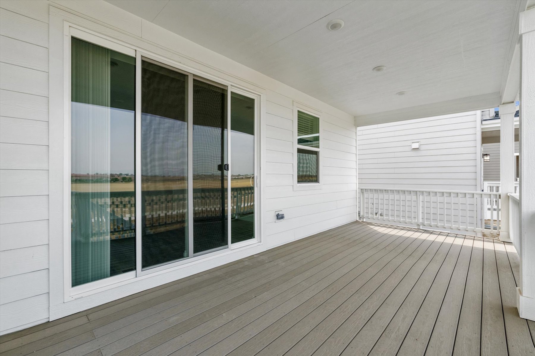 A room with windows and a wood floor.