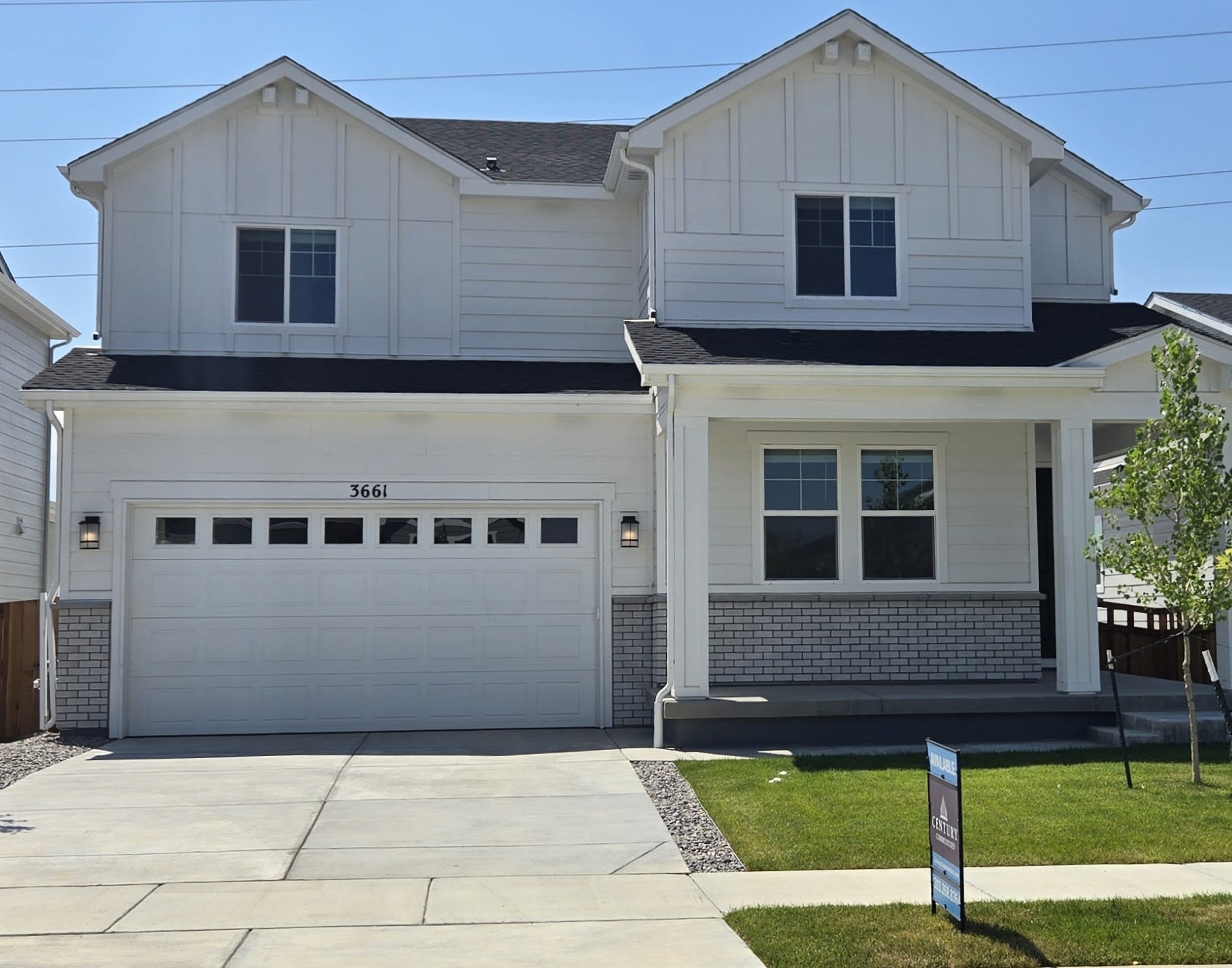 A white house with a garage.