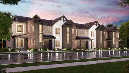 A large house with a pond in front of it.