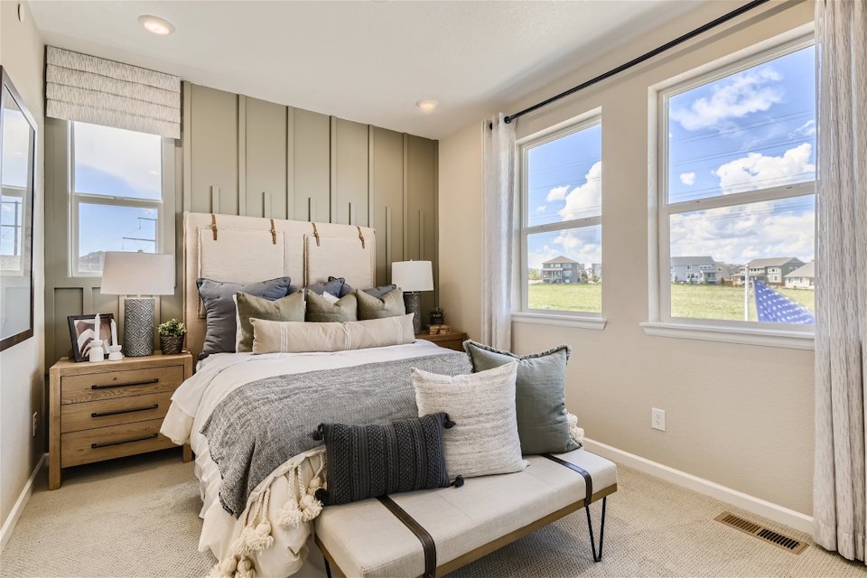 A bedroom with a large window.