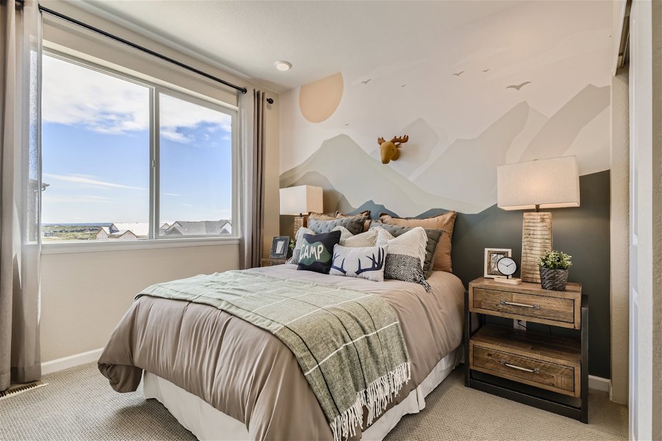A bedroom with a large window.