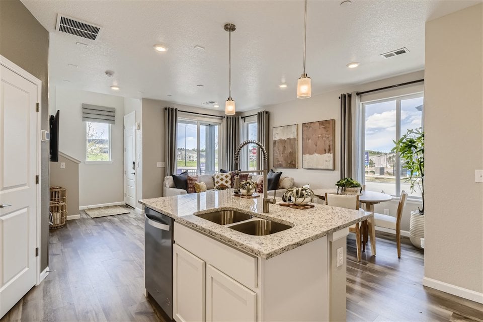 A kitchen with a marble island.