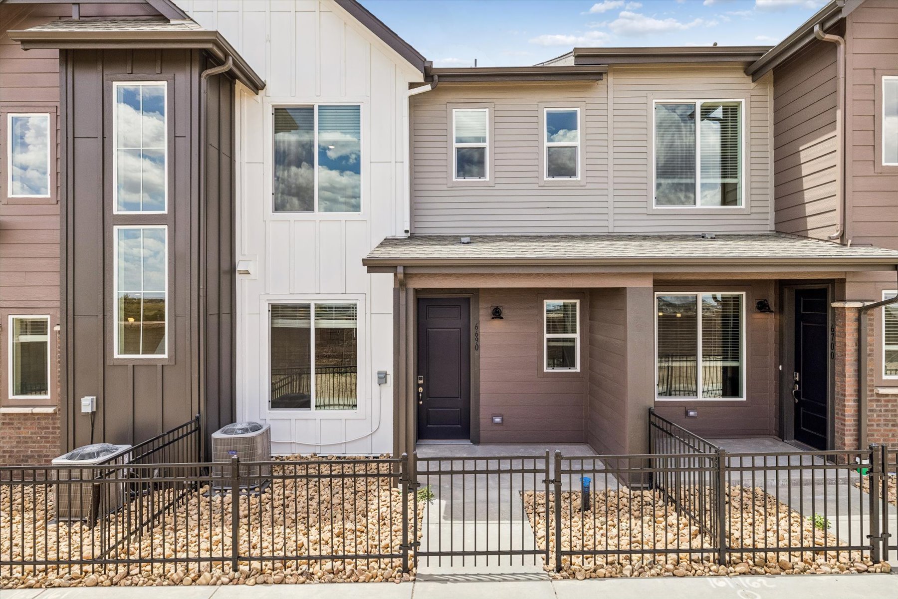 A house with a fence in front.