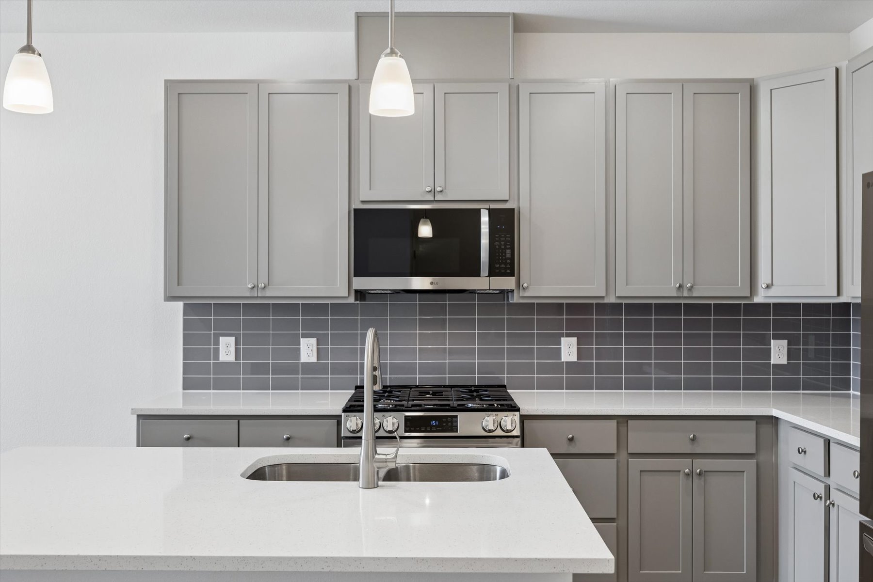 A kitchen with white cabinets.