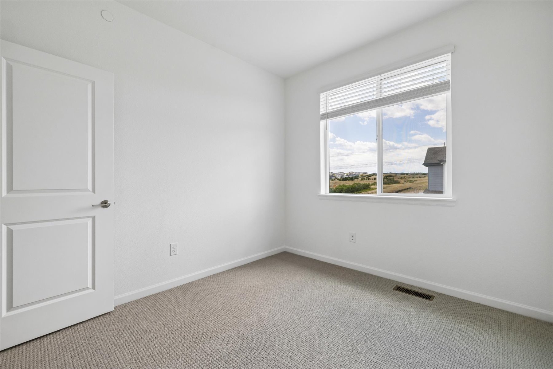 A room with a window and a door.