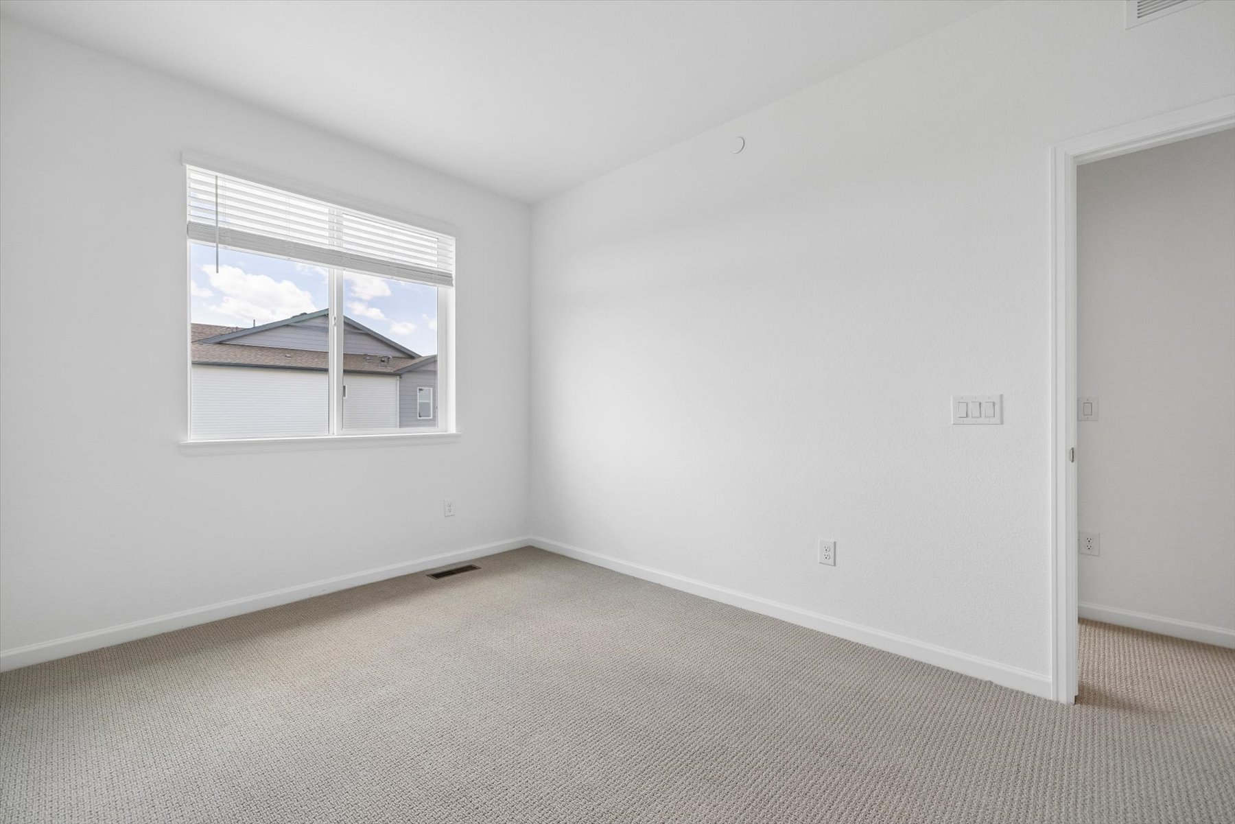 A room with a window and a door.