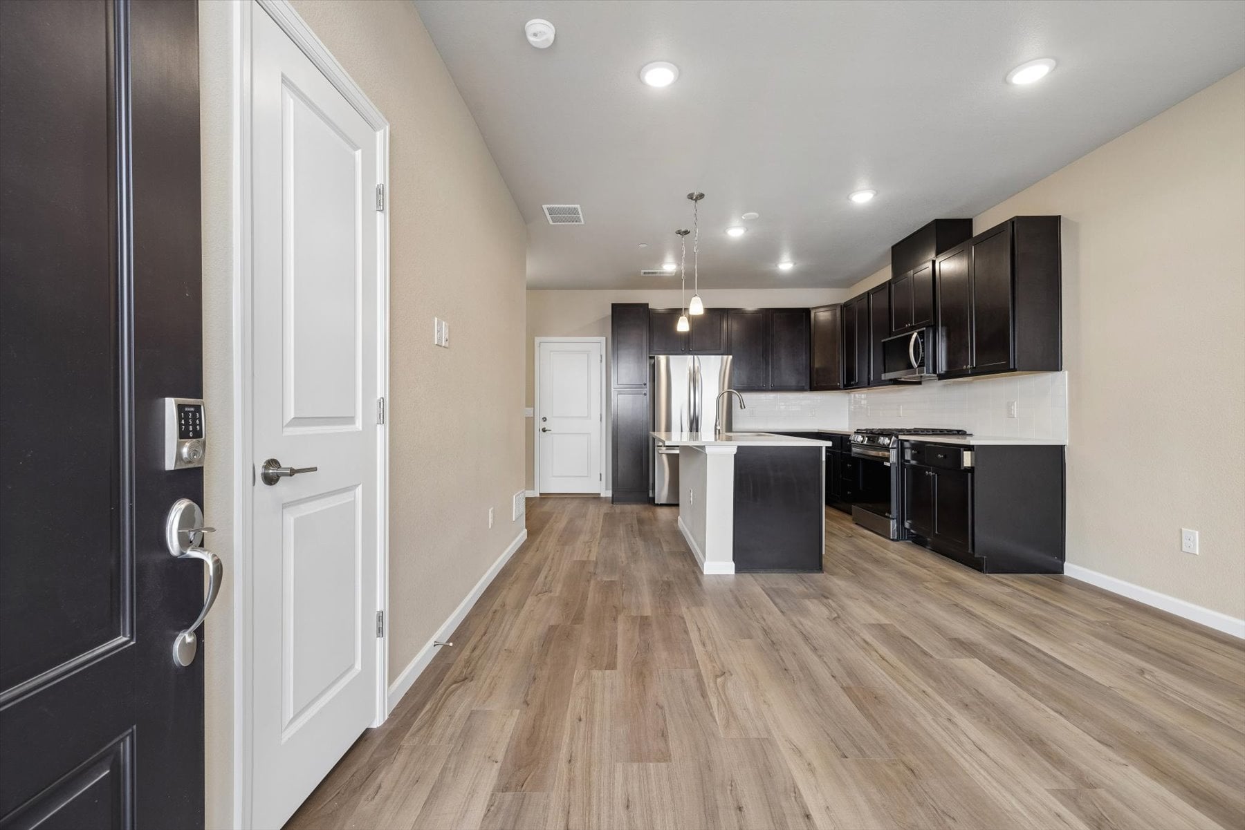 A kitchen with black cabinets.