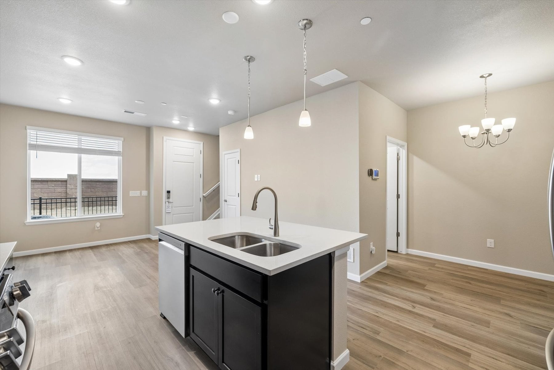 A kitchen with a sink and a large window.