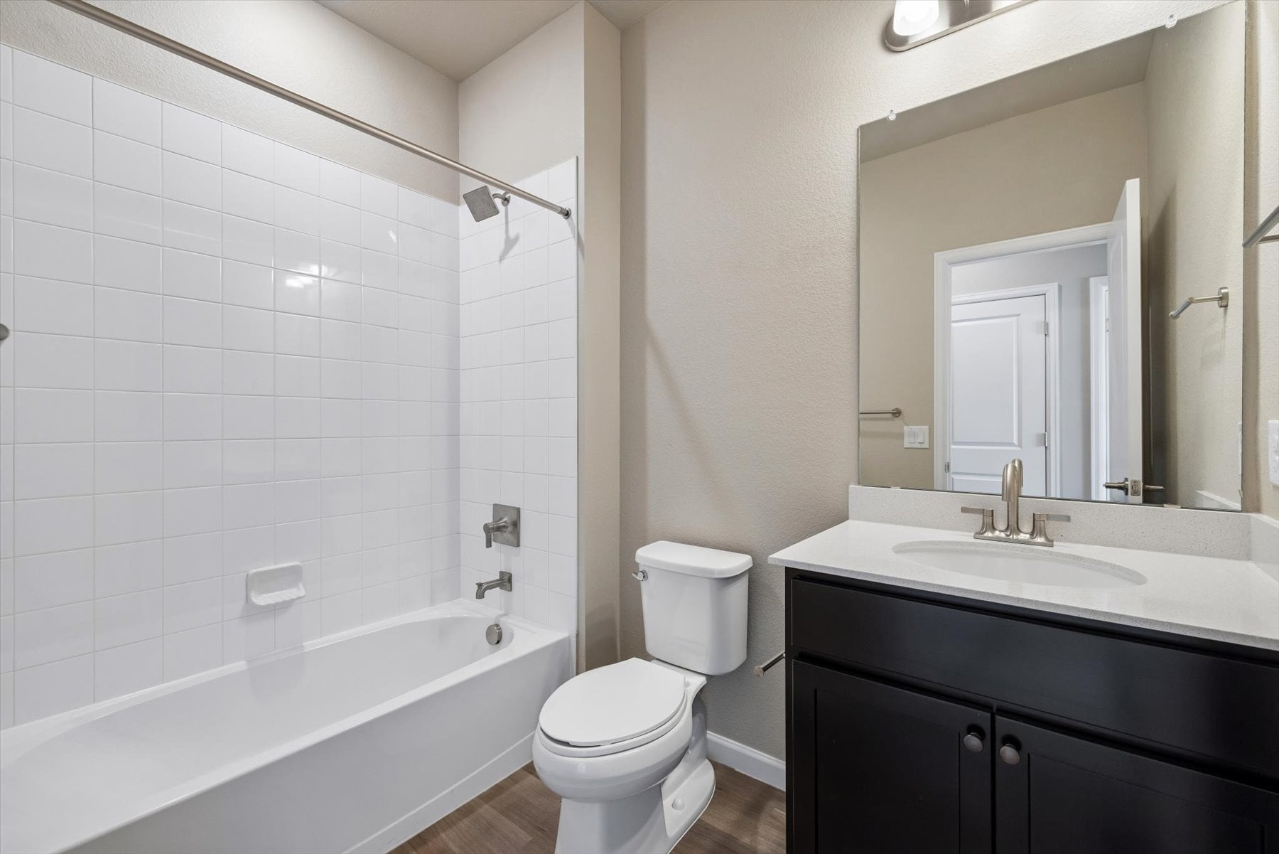 A bathroom with a tub sink and toilet.