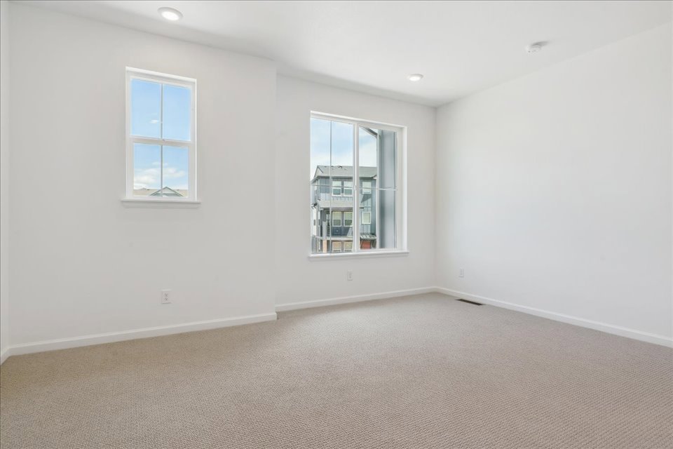 A room with a window and a carpet.