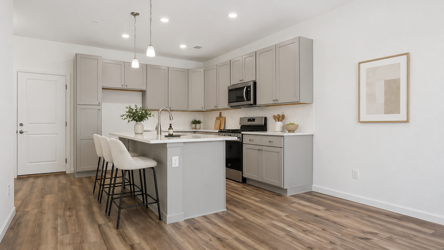 A kitchen with white cabinets.