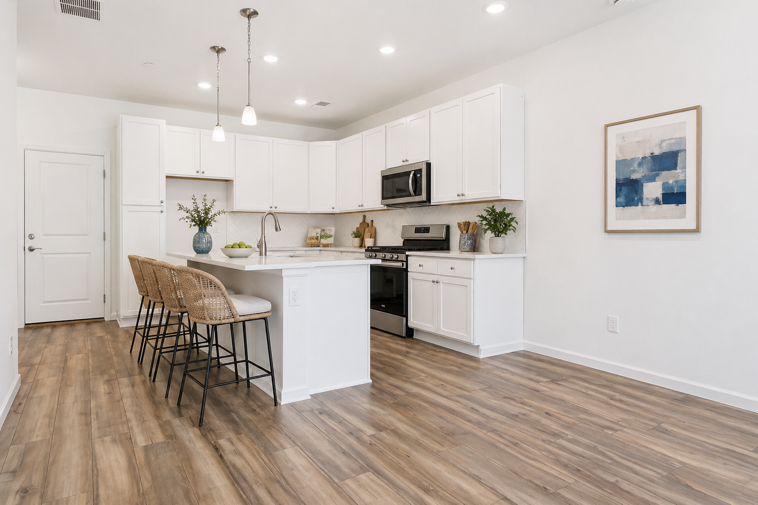 A kitchen with white cabinets.