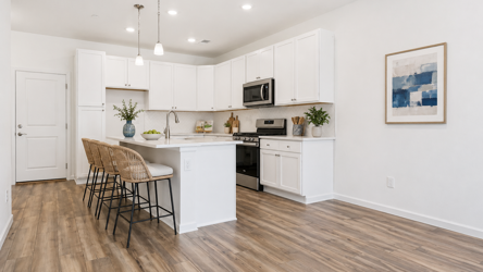 A kitchen with white cabinets.