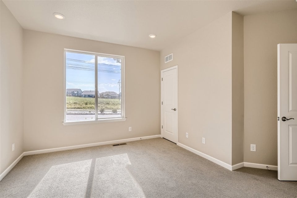 A room with a window and a door.