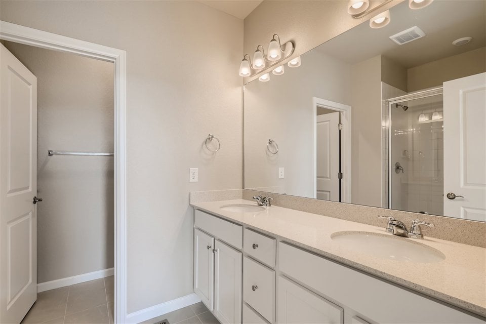 A bathroom with a large mirror.