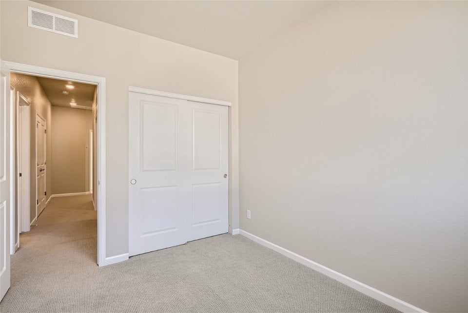 A hallway with white doors.