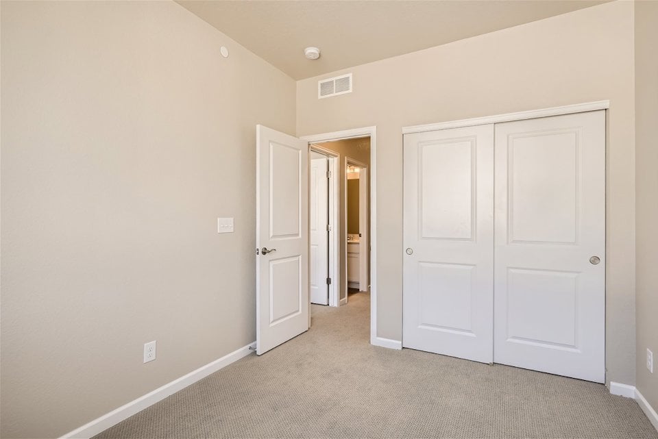 A hallway with white doors.