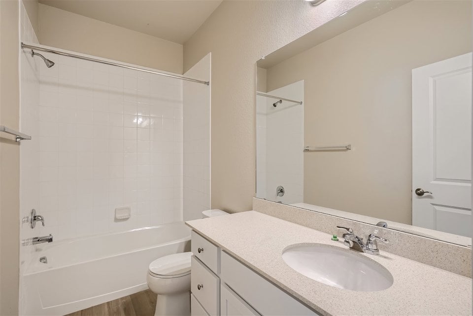 A bathroom with a sink and a shower.