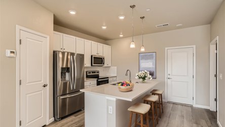 A kitchen with white cabinets.