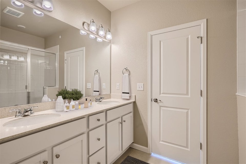 A bathroom with a large mirror.