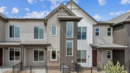 A large house with a fence in front of it.