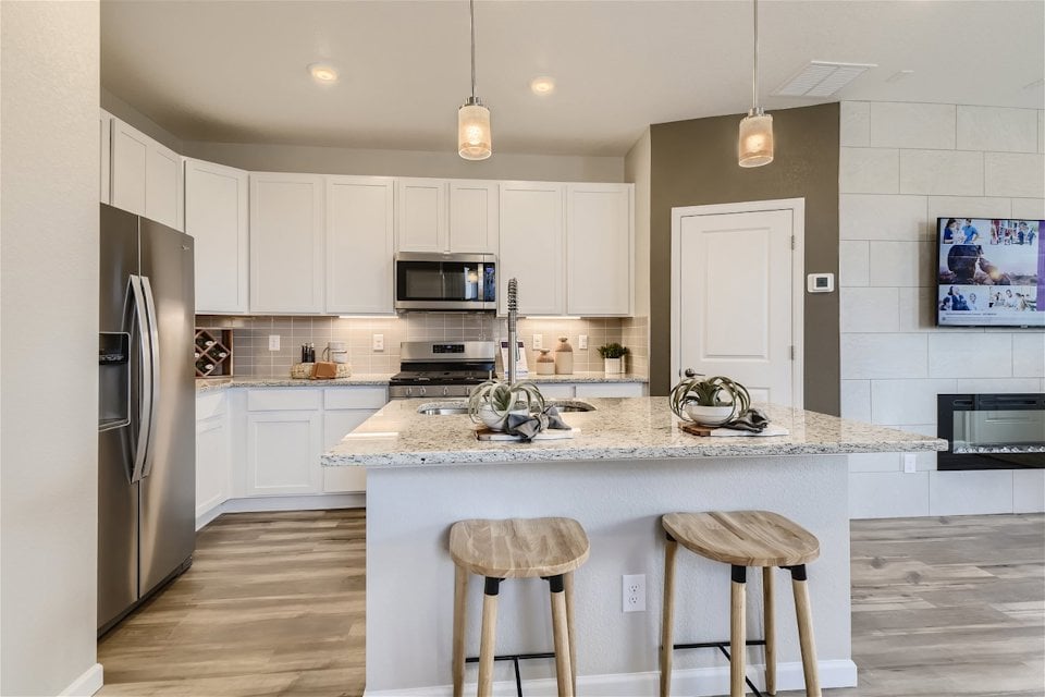 A kitchen with white cabinets.