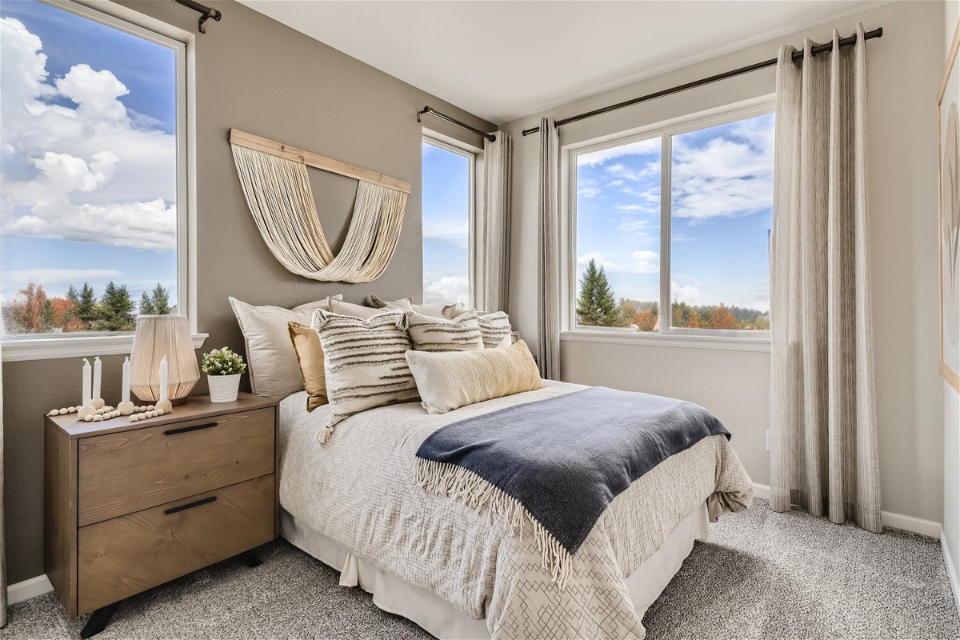A bedroom with a large window.