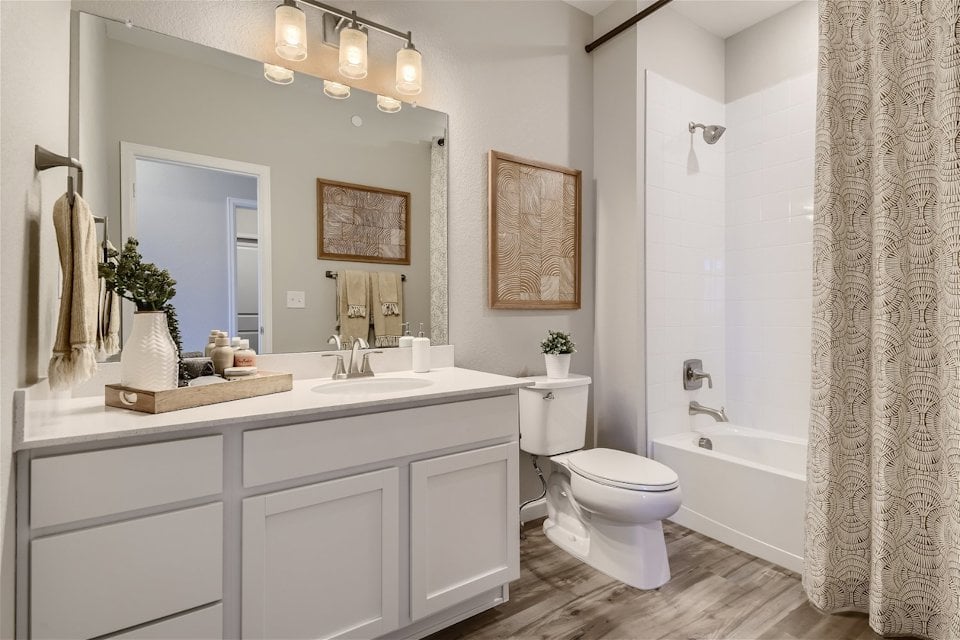 A bathroom with a tub toilet and sink.