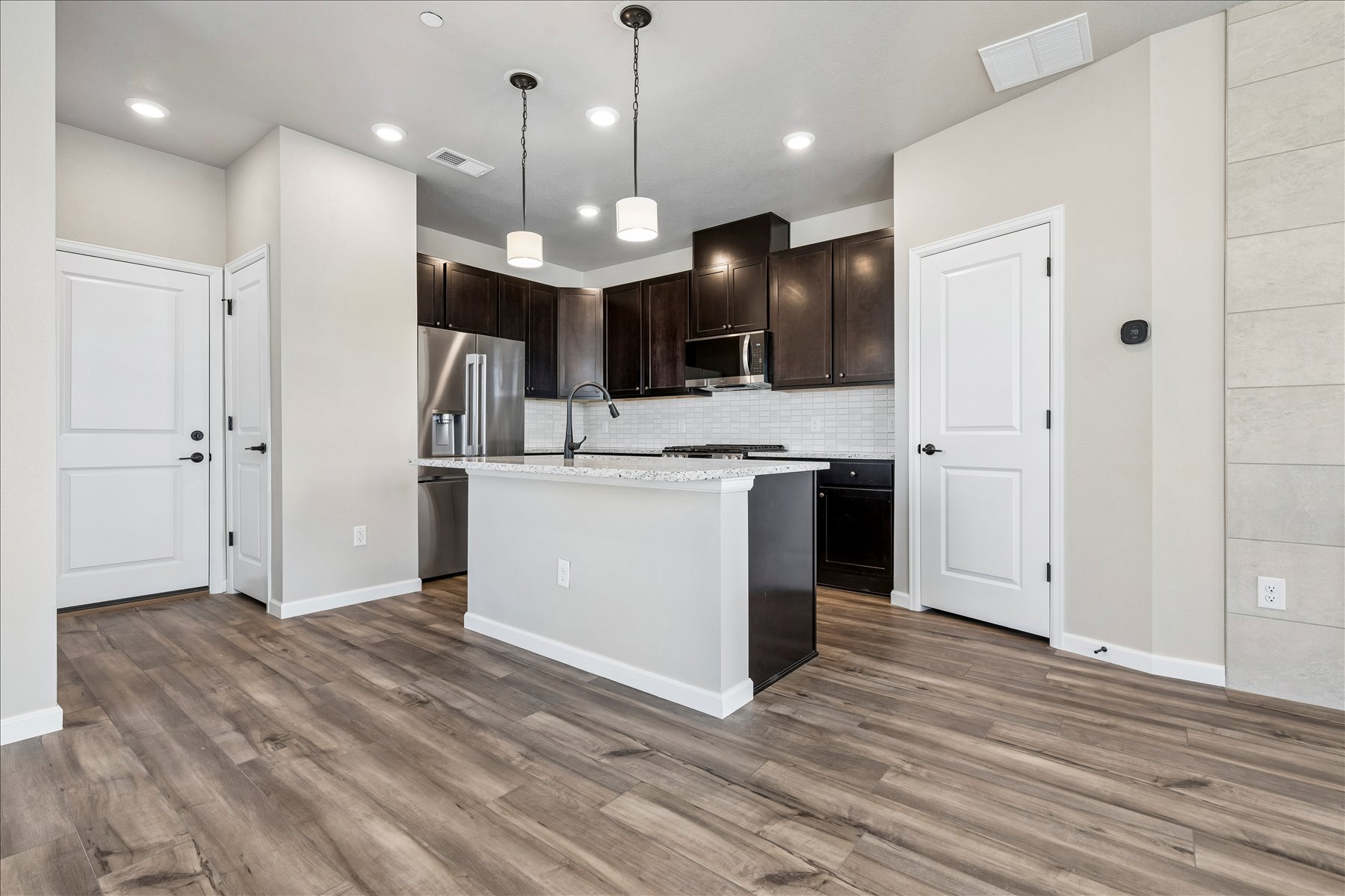 A kitchen with white cabinets.