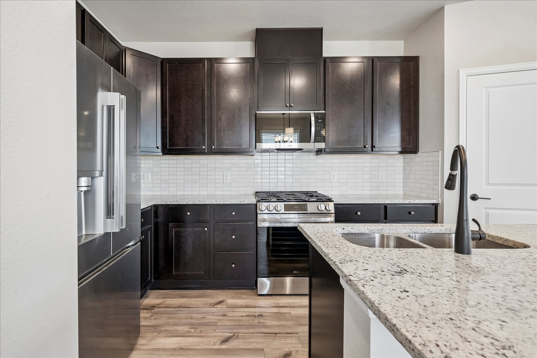 A kitchen with black cabinets.