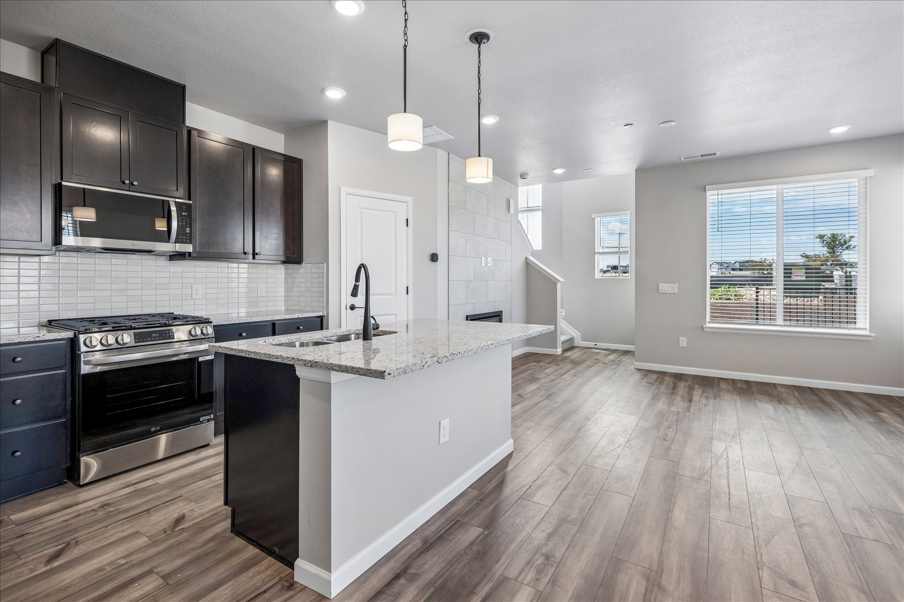 A kitchen with black cabinets.