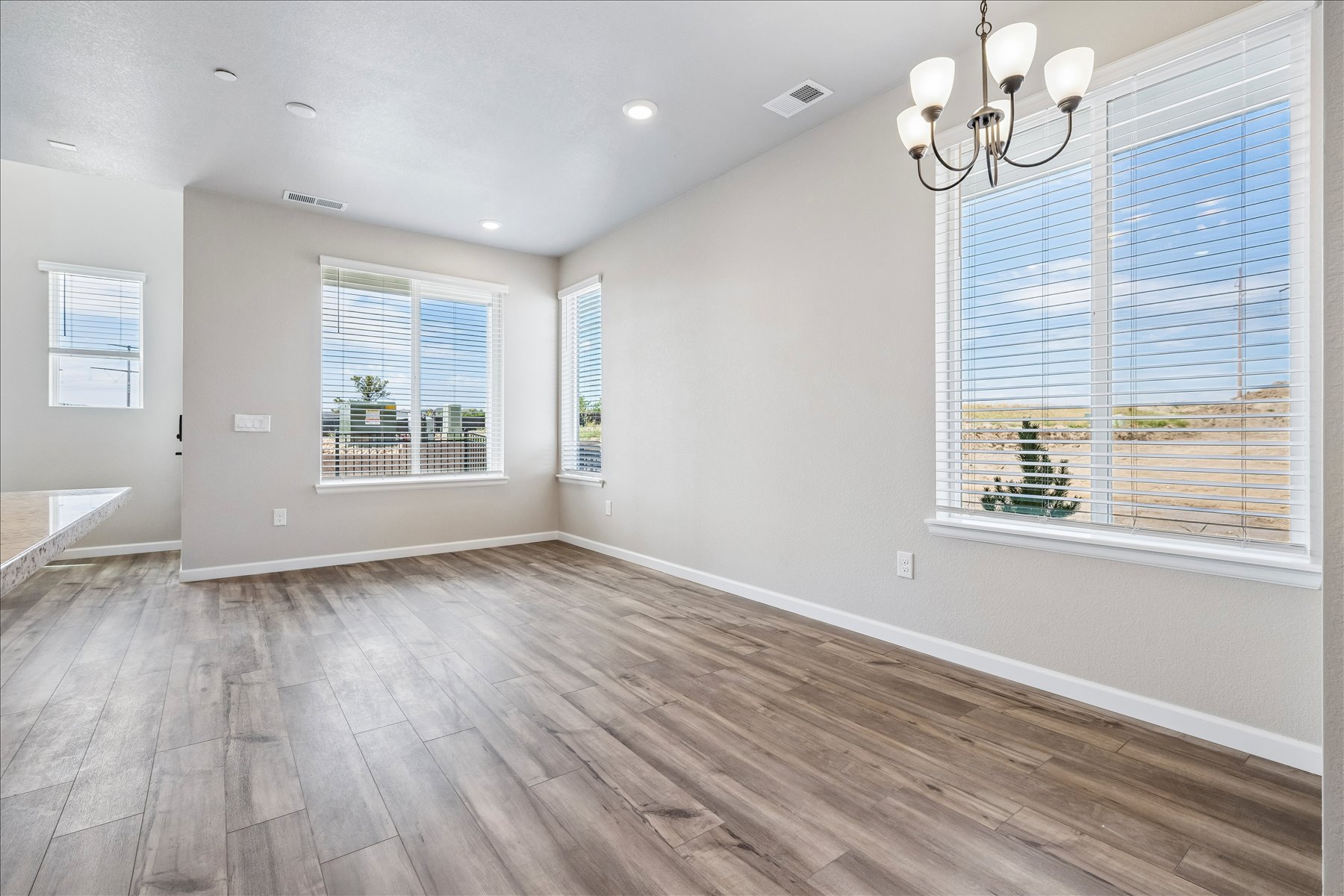 A room with a wood floor and windows.