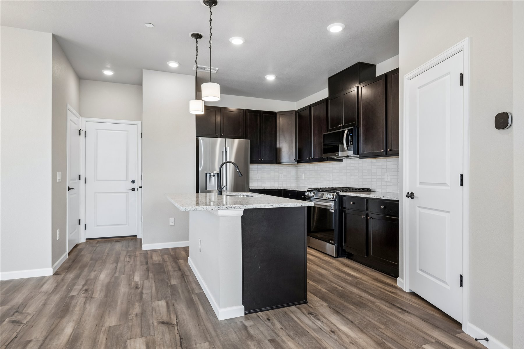 A kitchen with black cabinets.