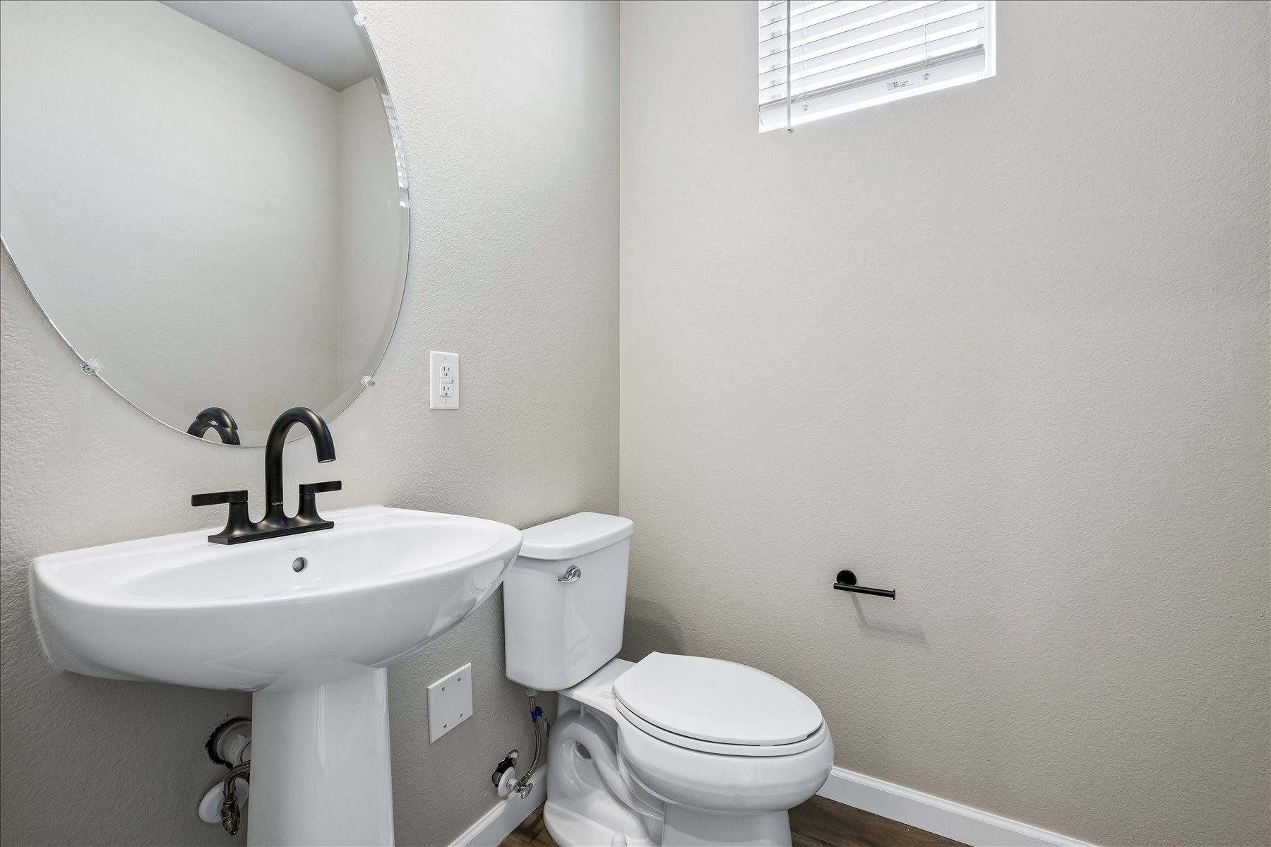 A bathroom with a sink and toilet.