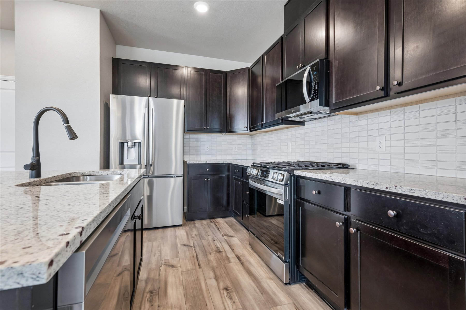 A kitchen with black cabinets.
