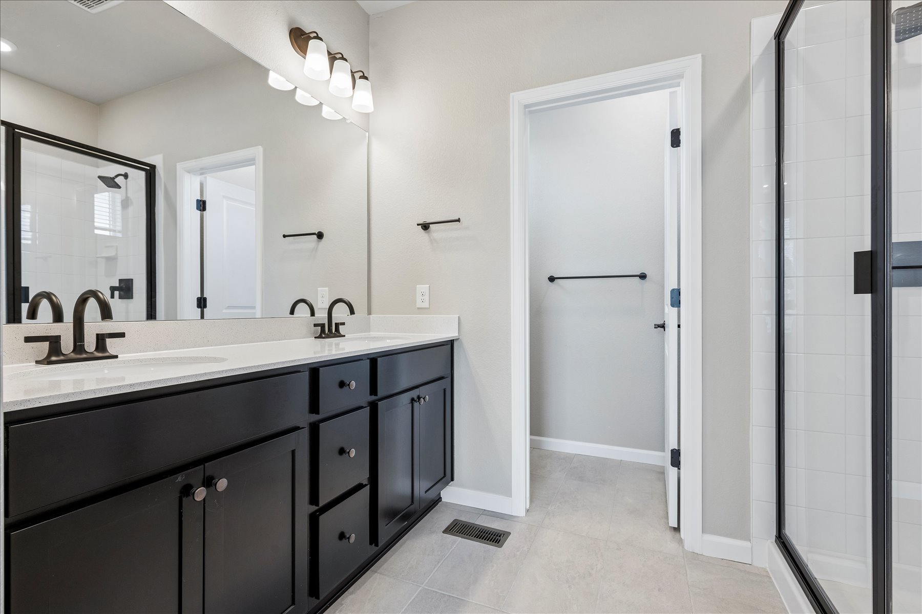 A bathroom with a shower unit and a sink.