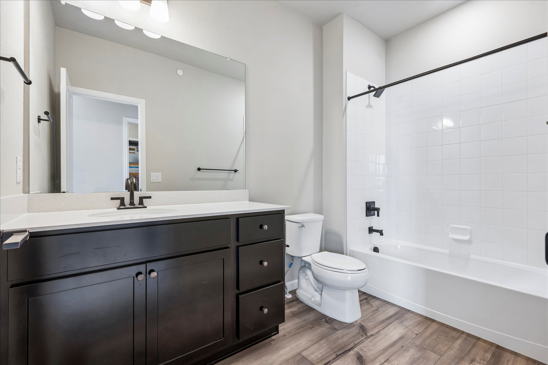 A bathroom with a tub toilet and sink.