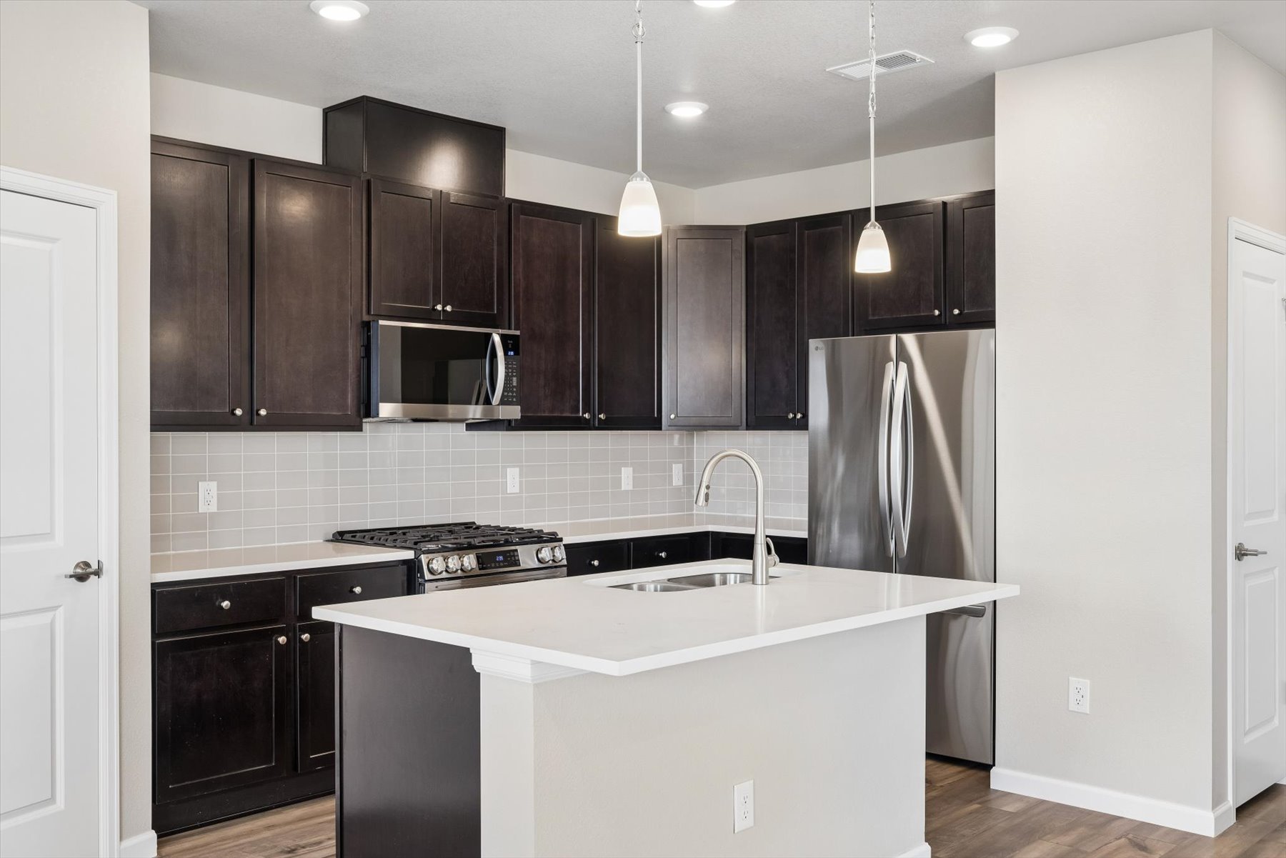 A kitchen with black cabinets.