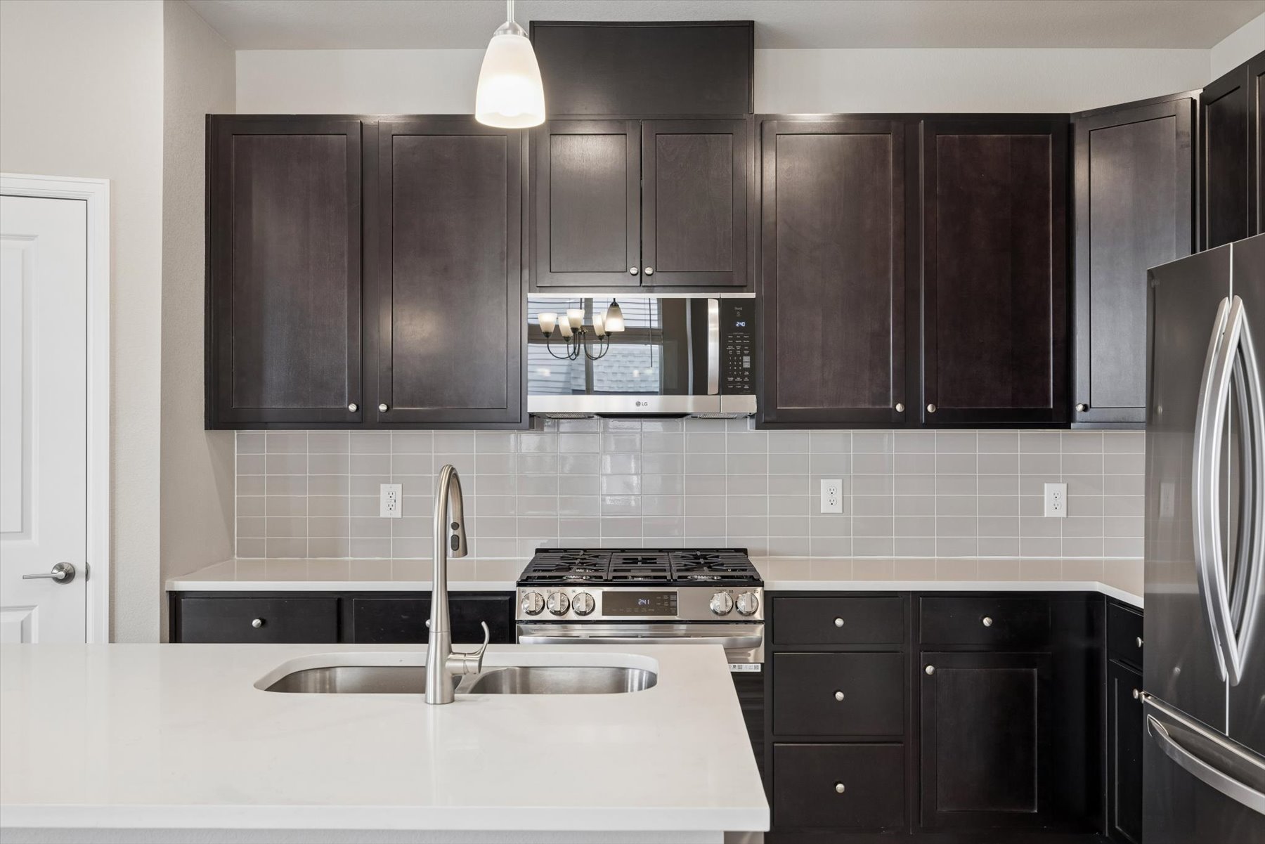 A kitchen with black cabinets.