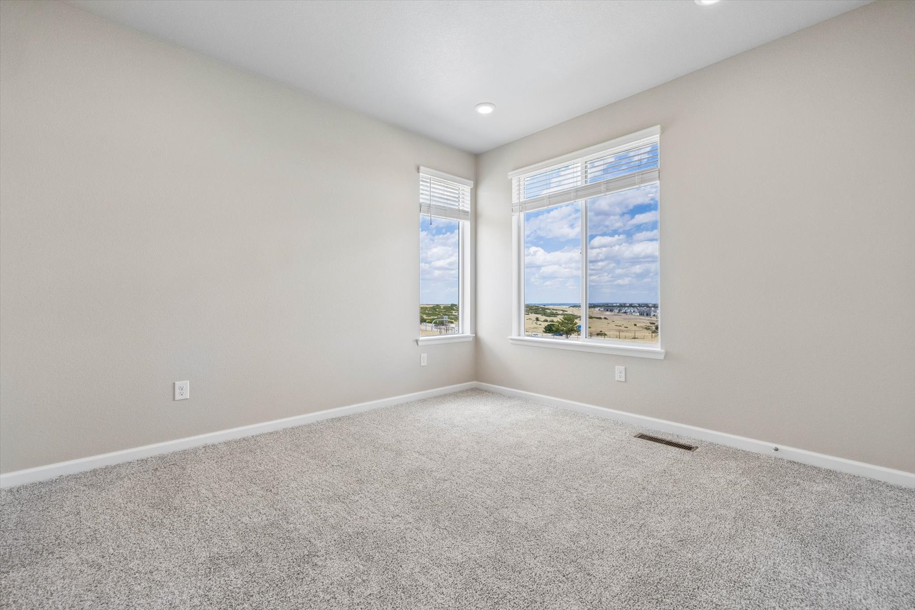 A room with a window and a carpet.