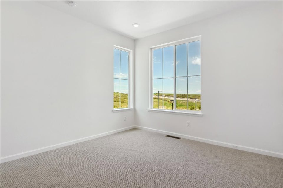 A room with a window and a carpet.