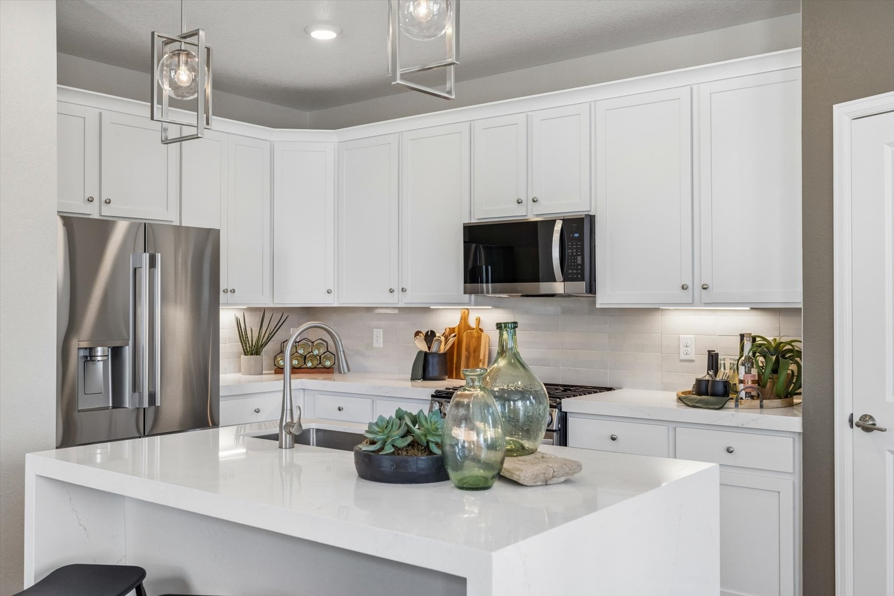 A kitchen with white cabinets.