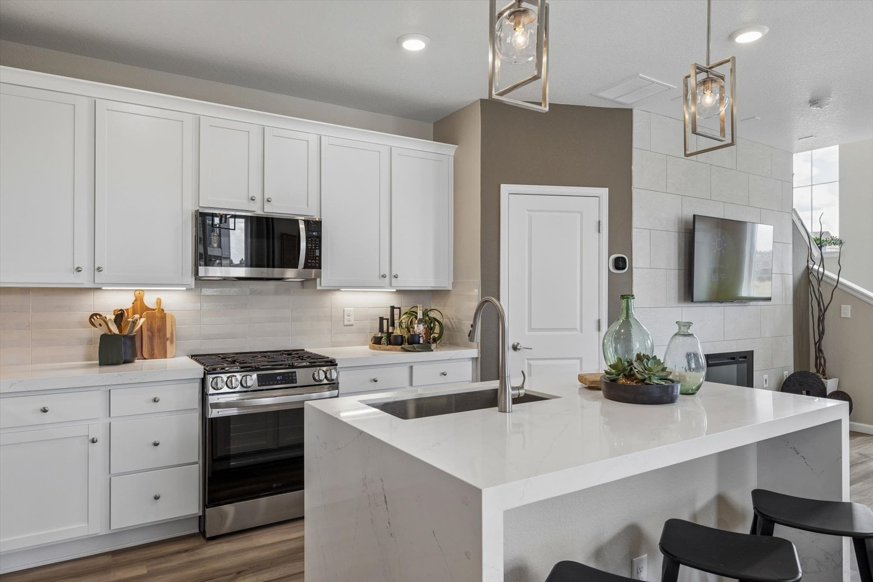 A kitchen with white cabinets.