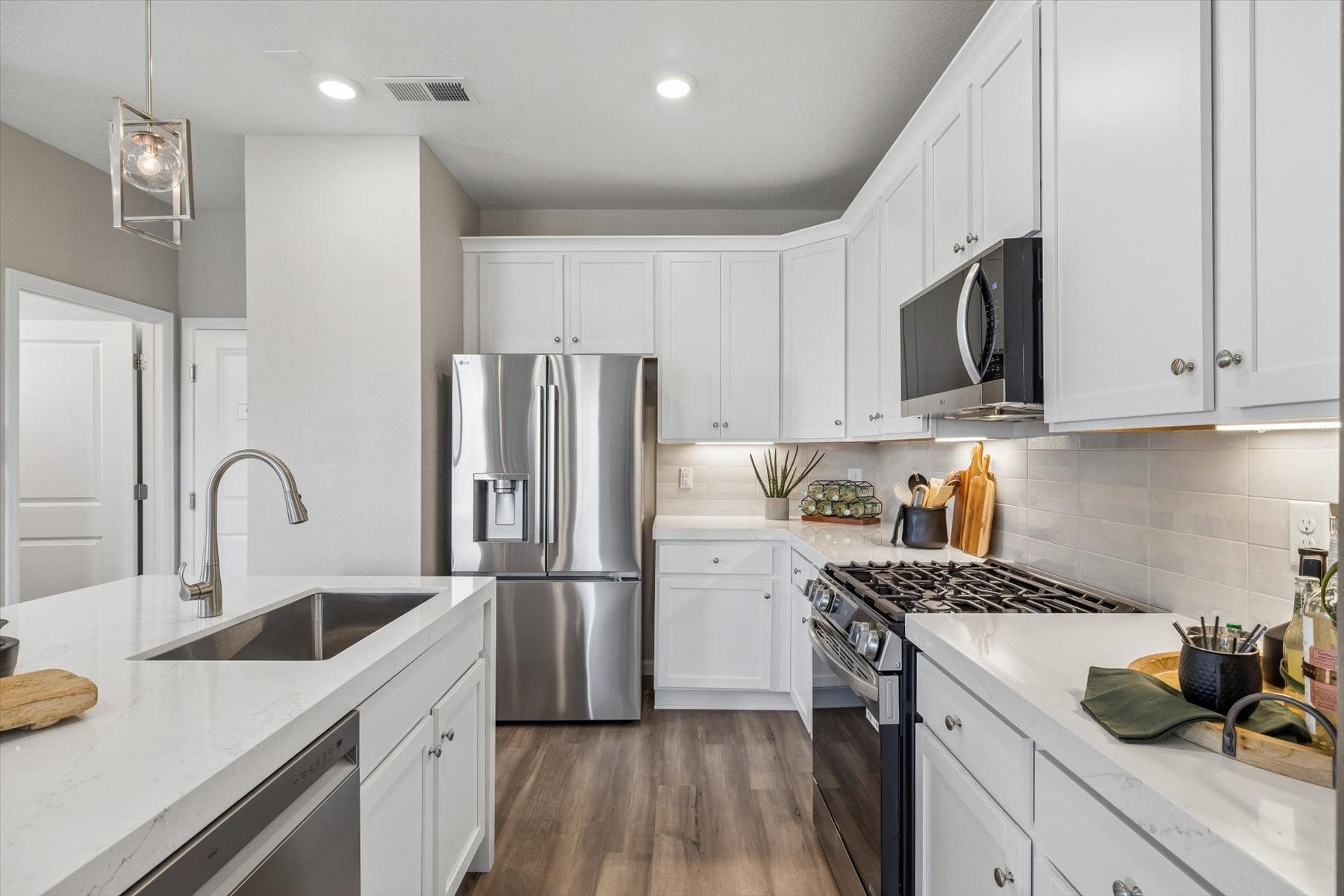 A kitchen with white cabinets.
