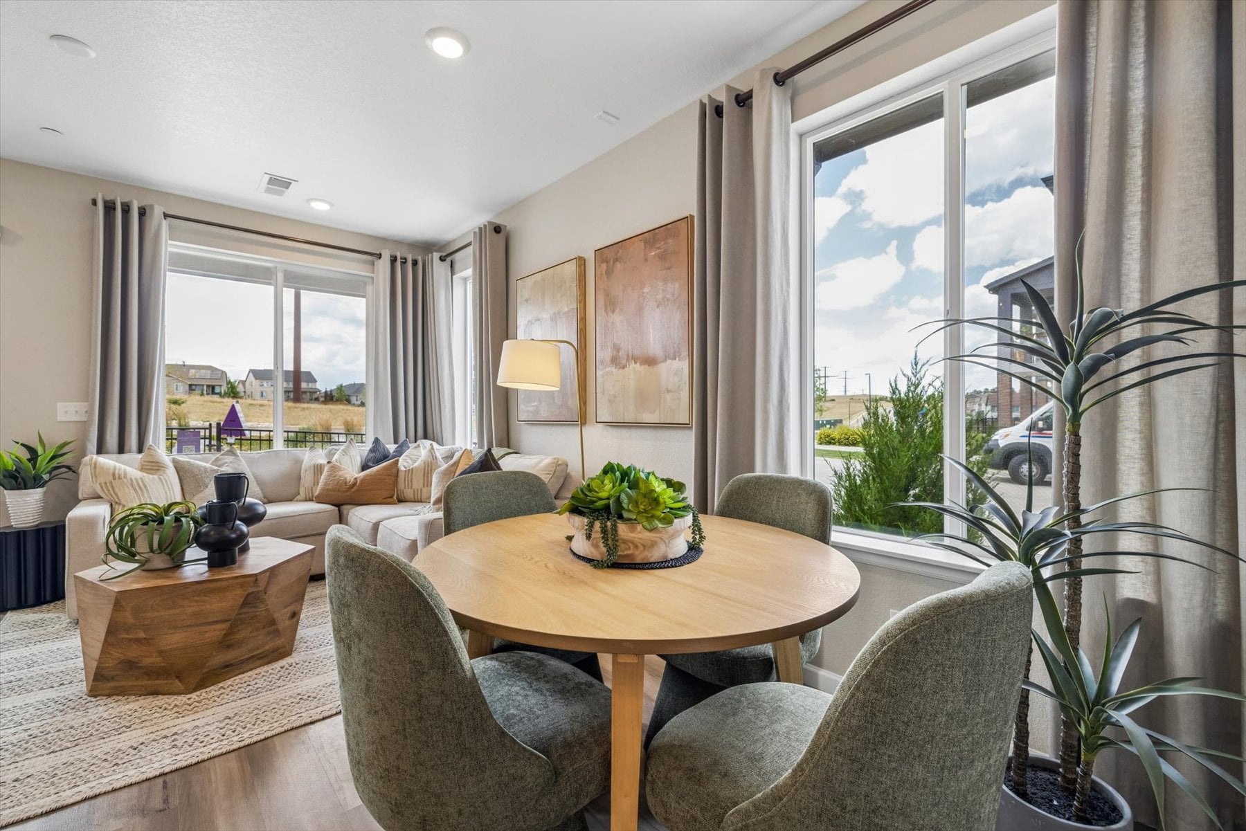 A living room with a table and chairs.